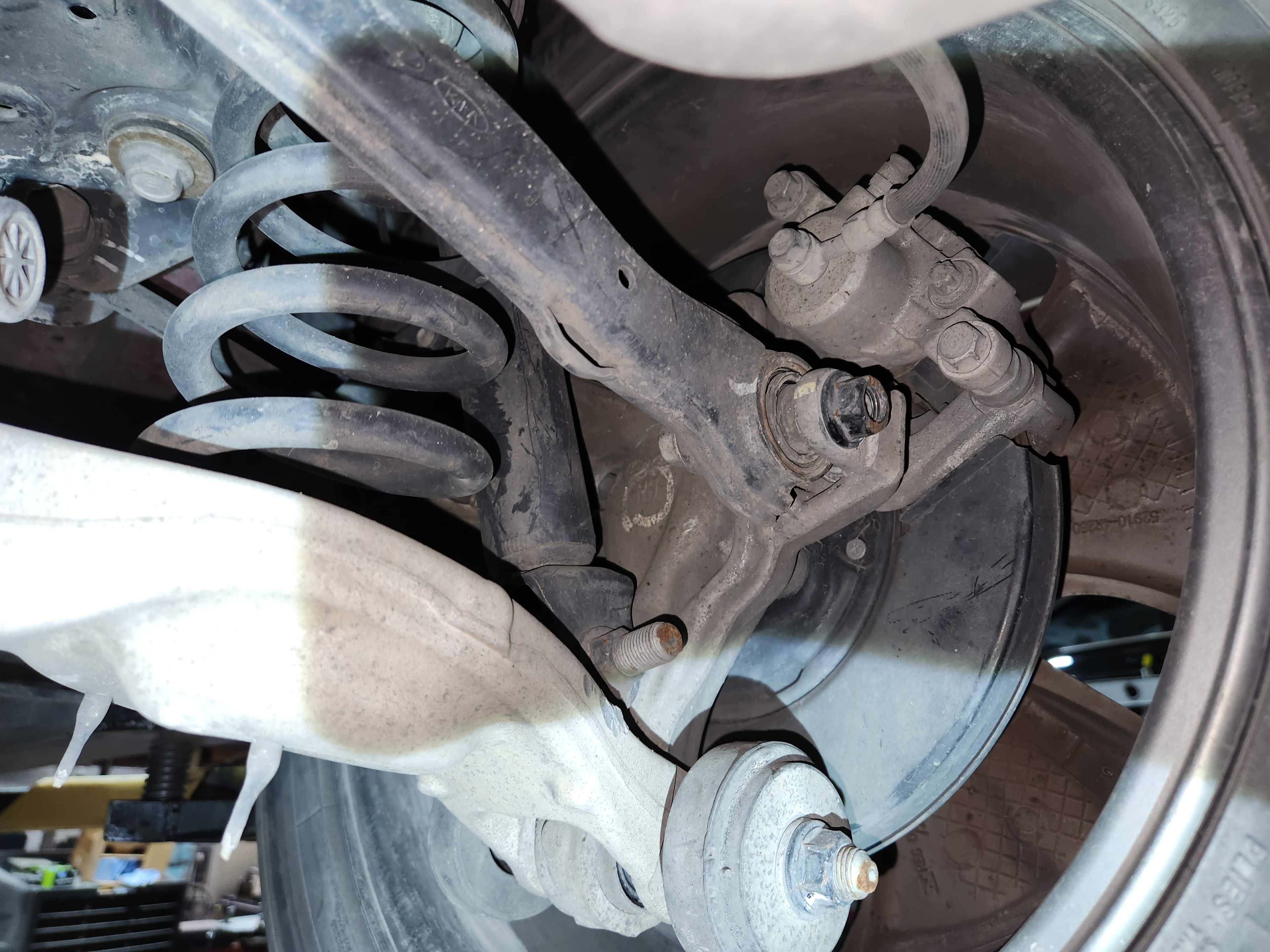 Brake caliper hardware and return spring components during brake service at Riley Auto Care San Marcos TX
