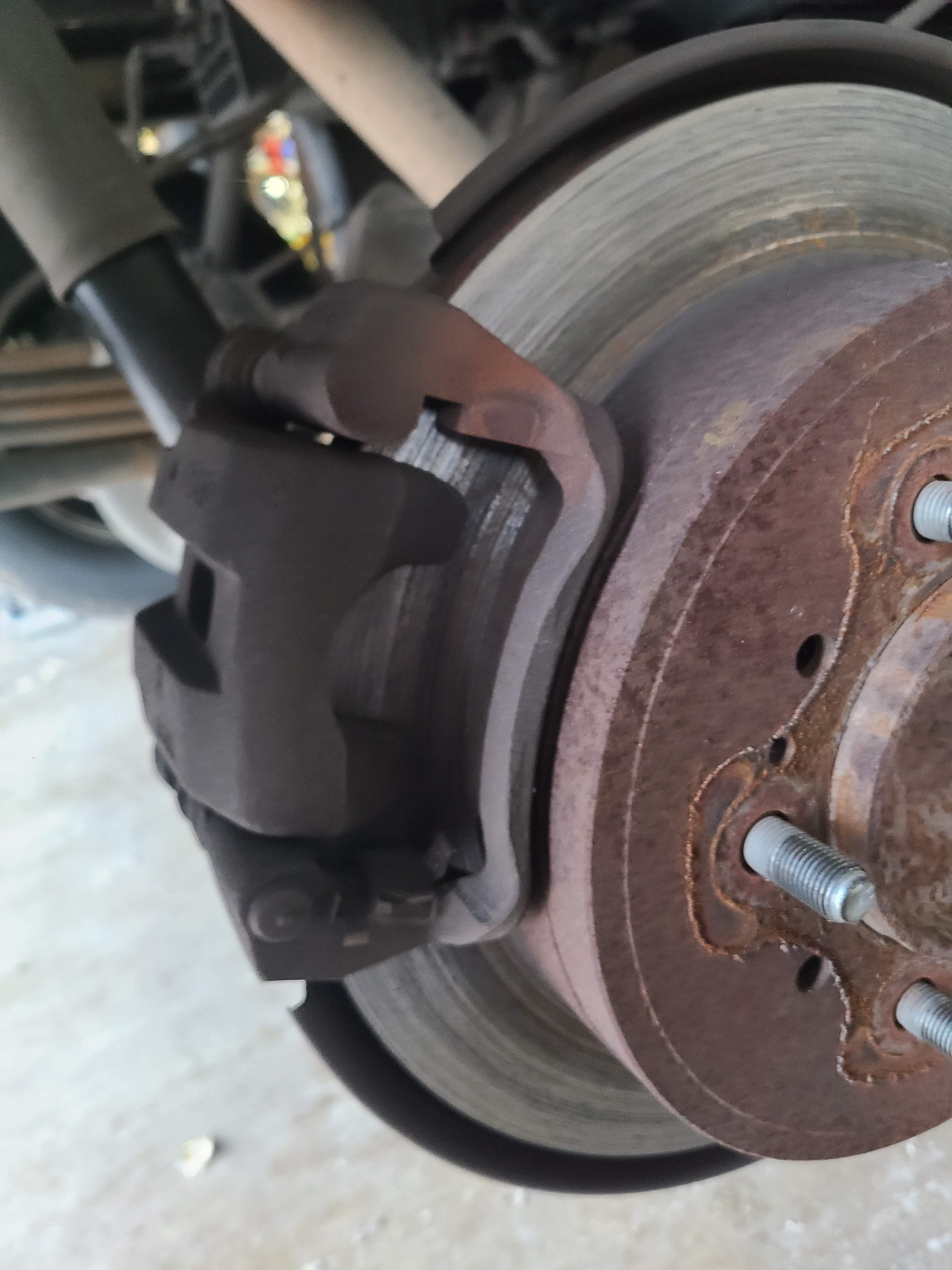 Worn brake rotor and caliper assembly inspected at Riley Auto Care in San Marcos TX