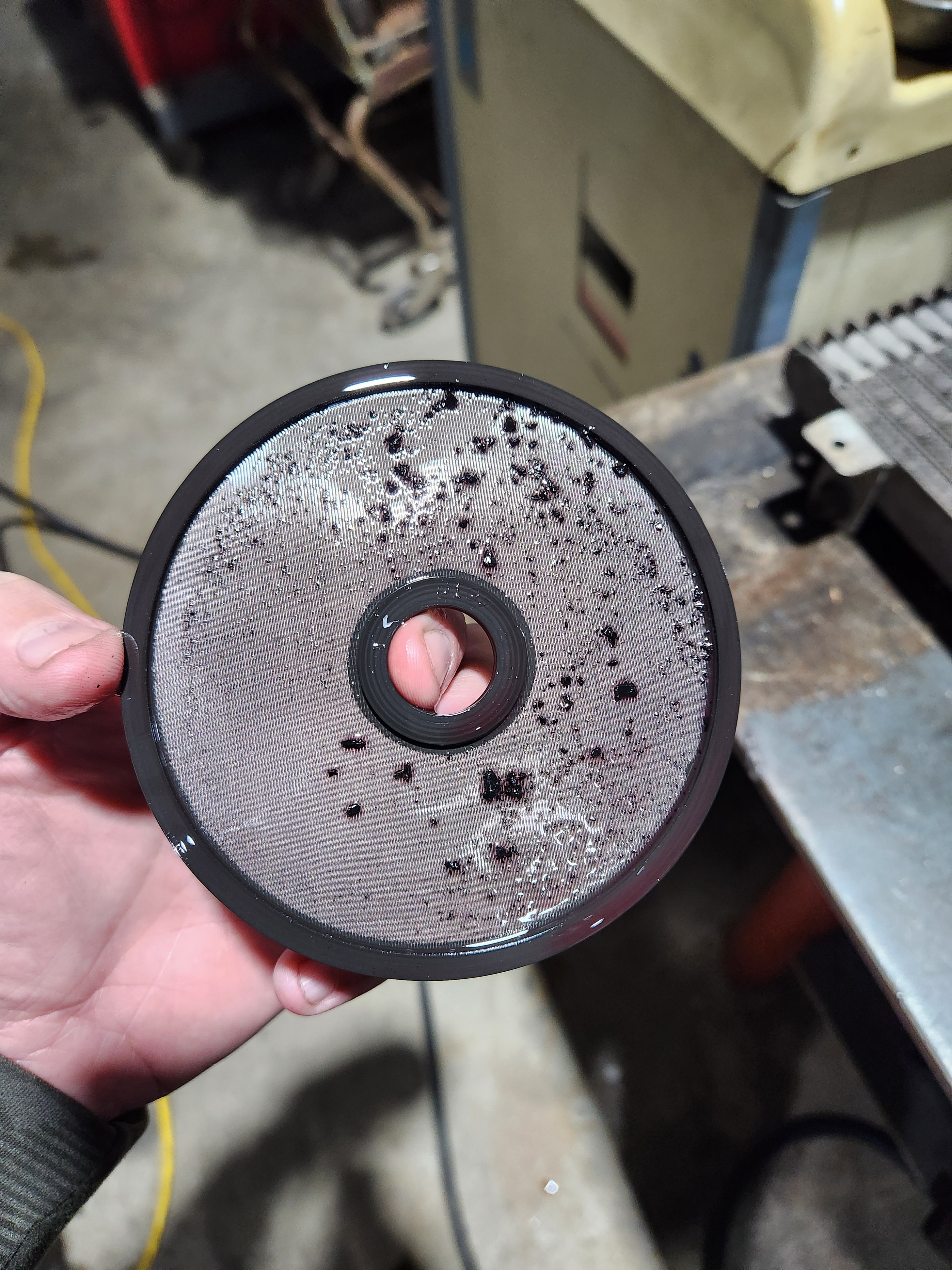 Transmission cooler flush return filter with black clutch material and metal debris removed by hot oil flush machine at Riley Auto Care San Marcos TX